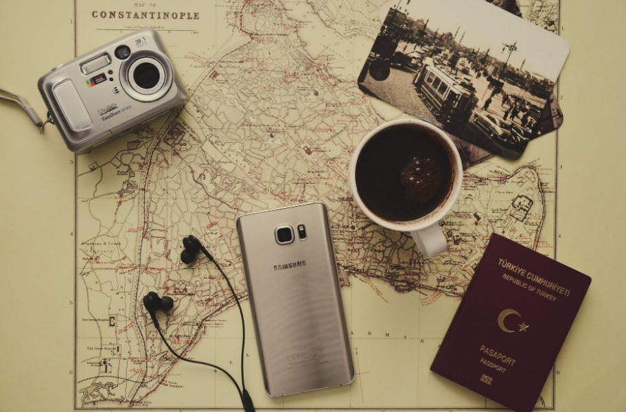 A camera, coffee, a phone, passport and a map